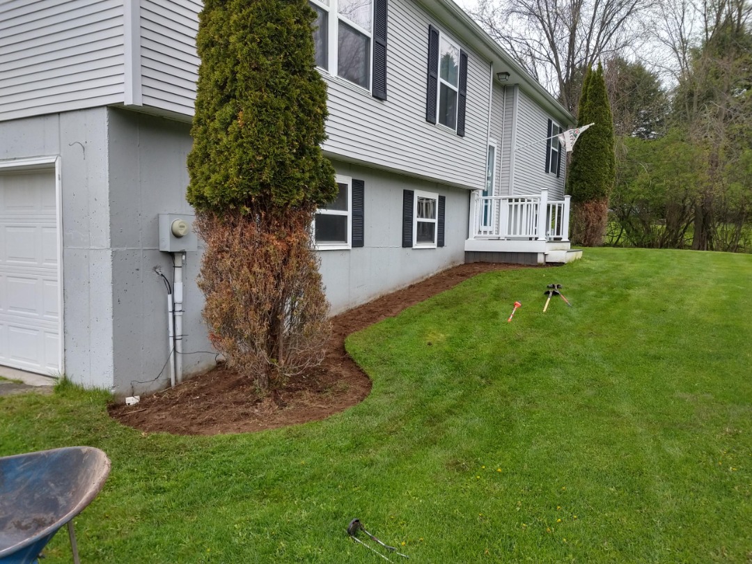 The process of edging and trimming a lawn along with fresh mulch for the perfect look.