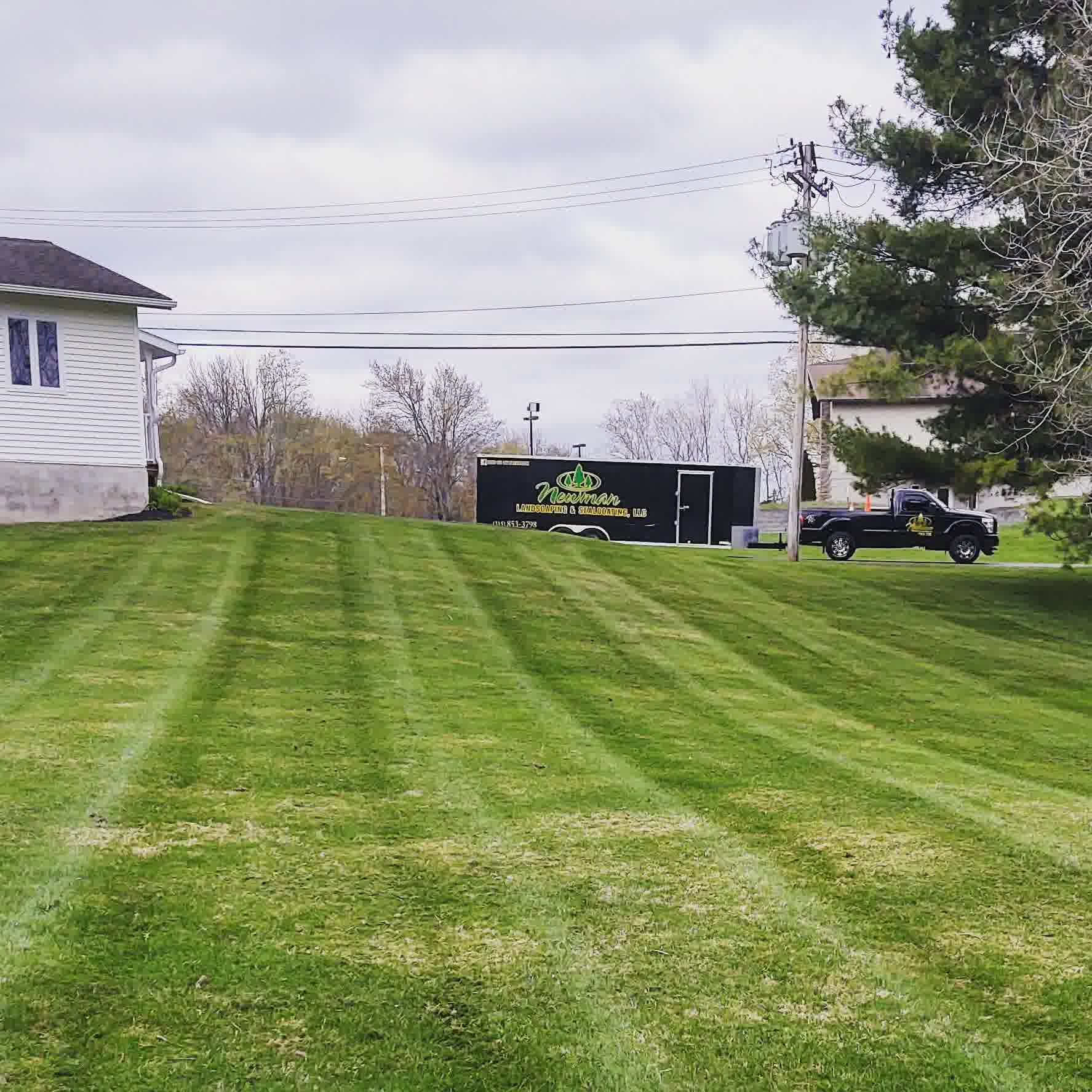 A lush lawn with amazing drainage and our branded work truck in the back.