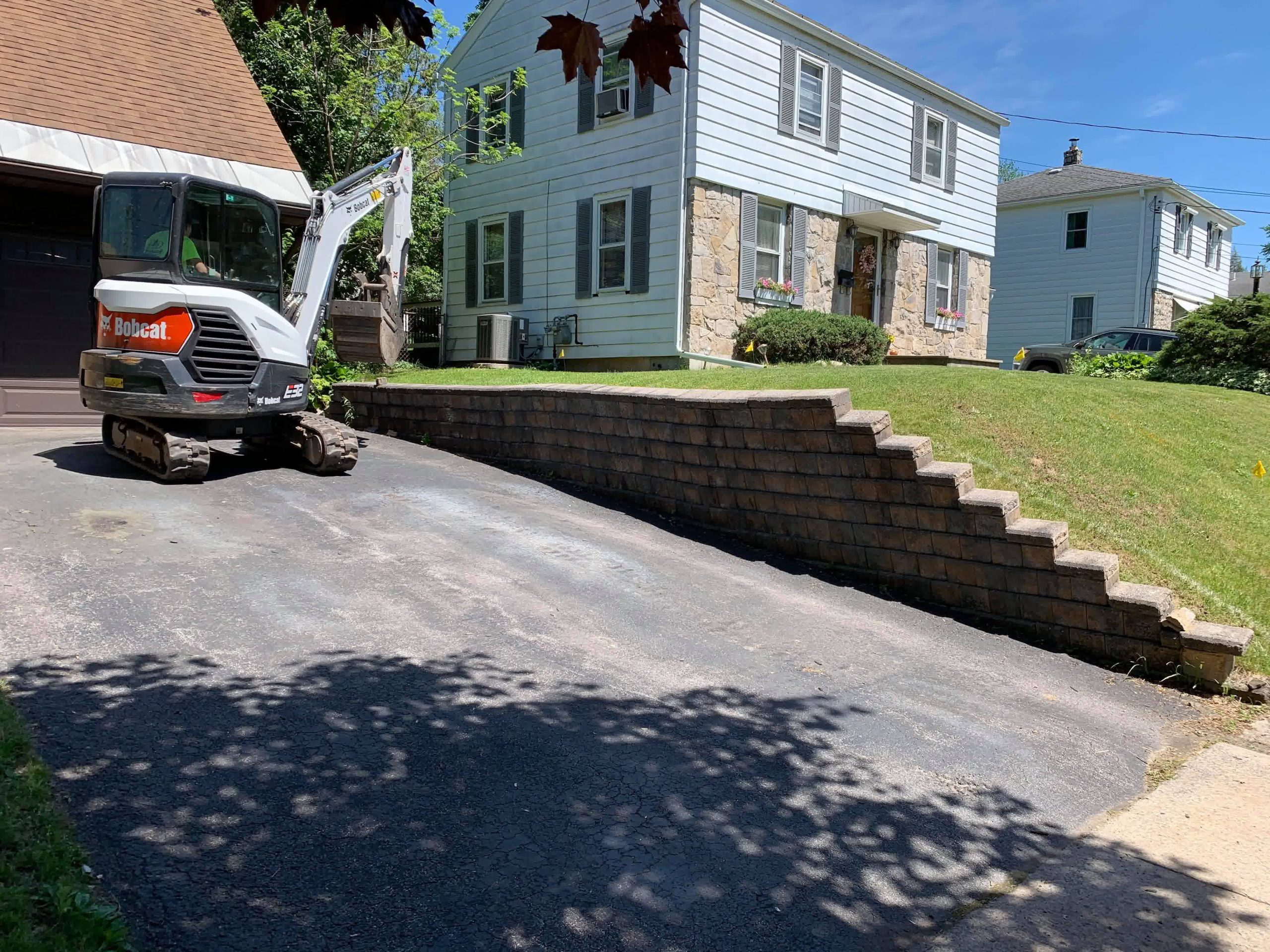 A sturdy retaining wall installed by our crew to help a client’s graded lawn.
